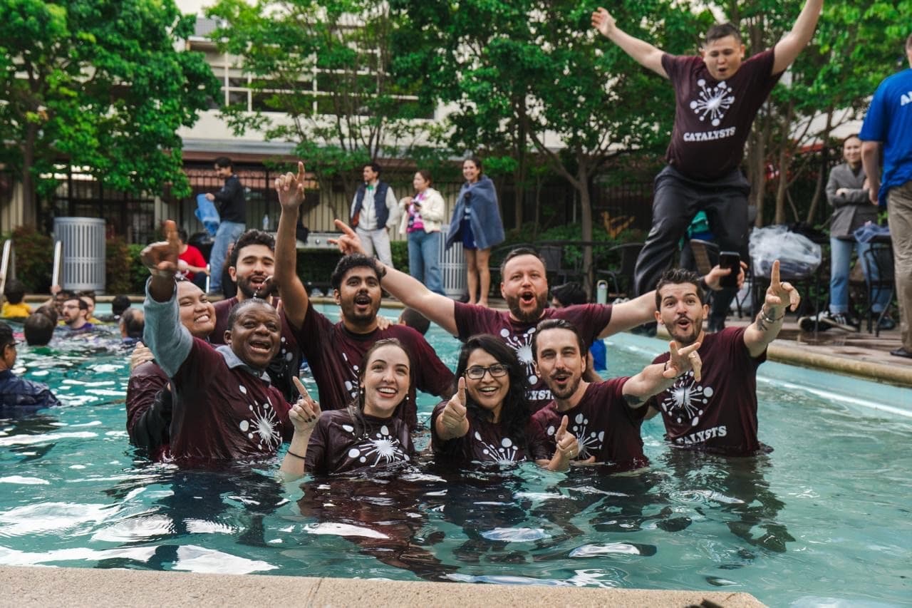 The Catalysts cohort celebrating together in a pool.