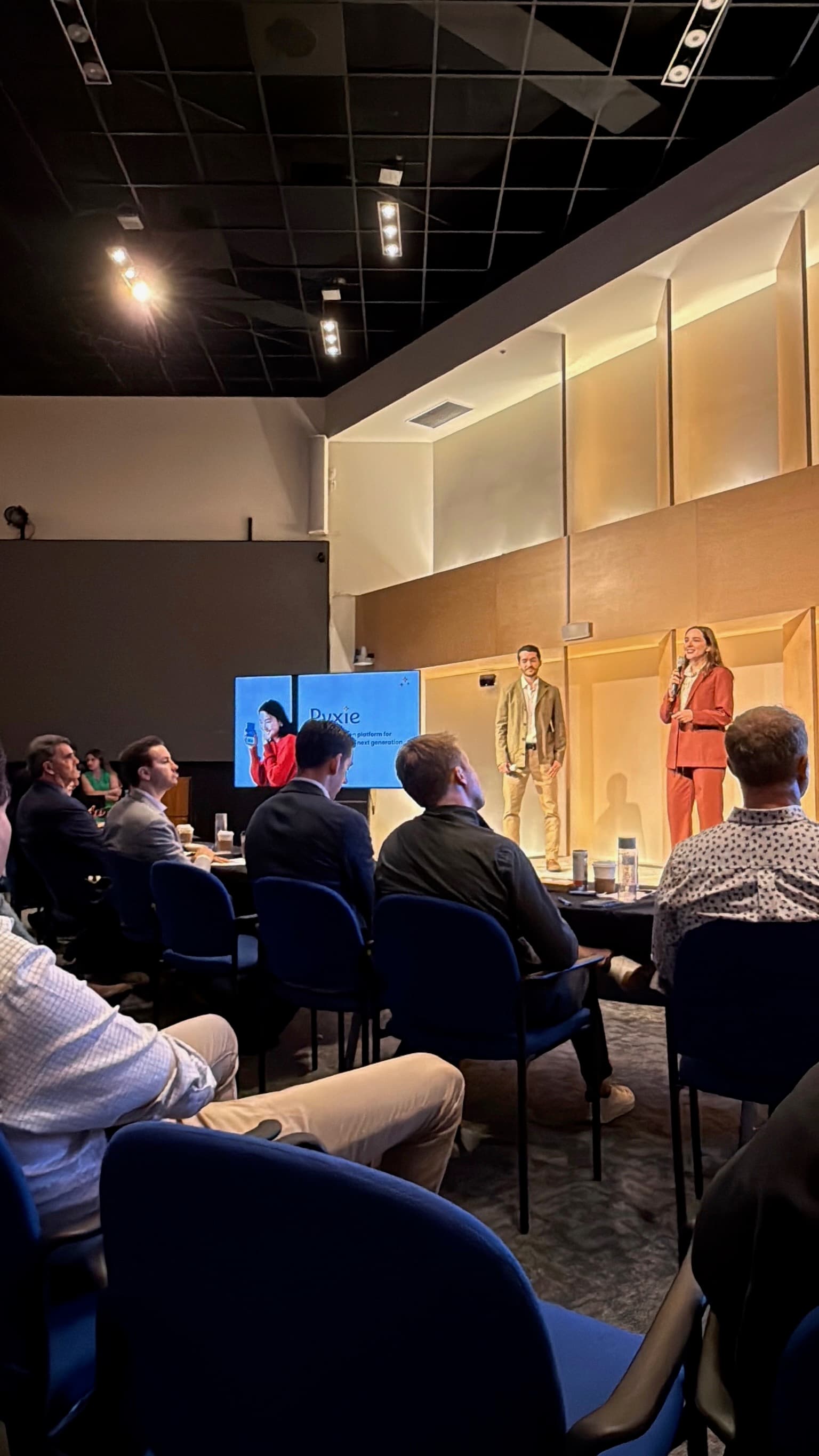 Jenna and Evan presenting Pyxie on stage.